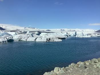 Landscape of glacier lagoon with floating iceberg