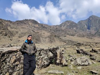 Man standing on mountain against sky