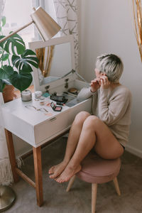 Woman sitting on chair at table