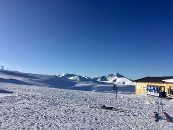 Scenic view of snowcapped mountains against clear blue sky