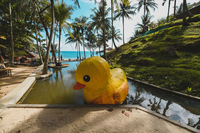 Yellow floating on water by sea against sky