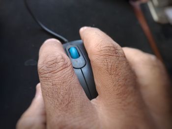 Cropped hand using computer mouse