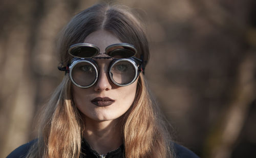 Close-up portrait of young woman wearing sunglasses