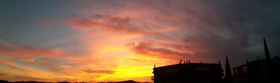 Scenic view of dramatic sky over city