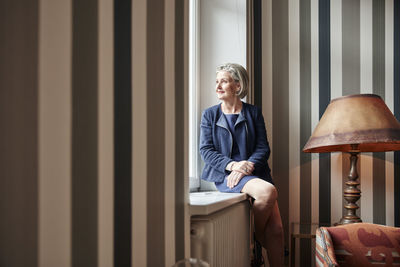 Senior woman looking out of window