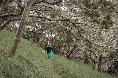 Full length of woman walking in forest