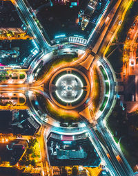 High angle view of illuminated city street and buildings at night