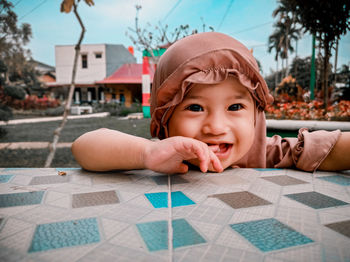 Portrait of smiling boy on table