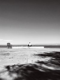 Silhouette man on beach against clear sky