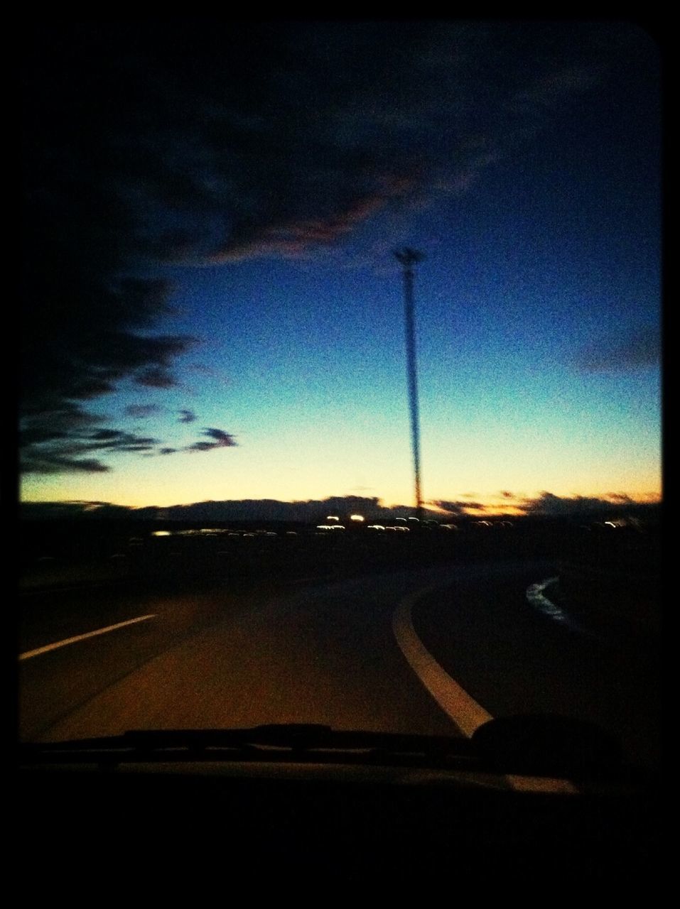 transportation, road, sky, sunset, transfer print, landscape, road marking, silhouette, auto post production filter, cloud - sky, dusk, the way forward, street, car, dark, nature, highway, country road, land vehicle, scenics