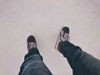 Low section of man standing on tiled floor