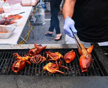 Man preparing food on barbecue grill