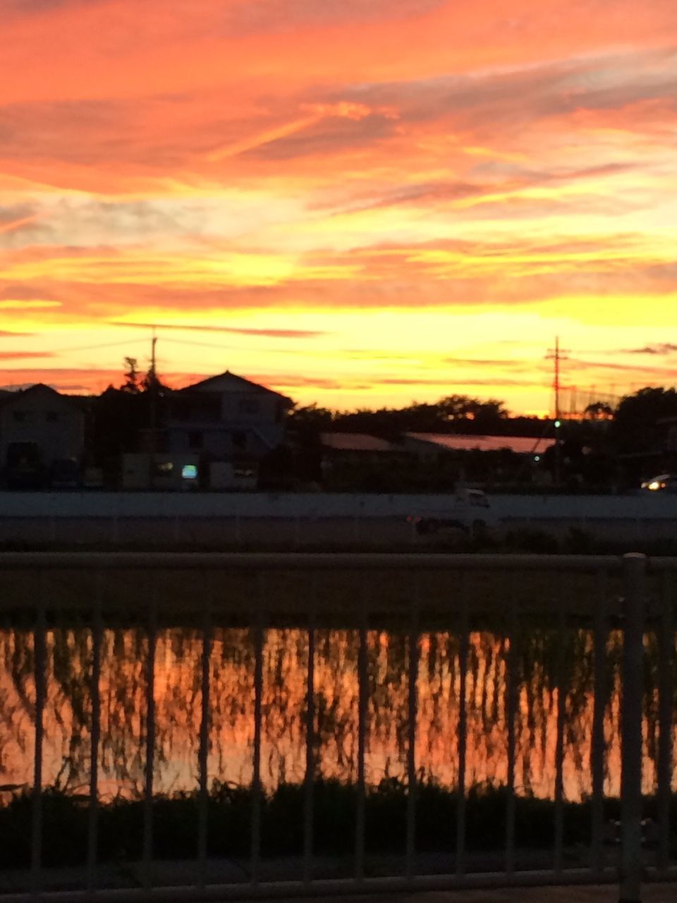 sunset, building exterior, orange color, architecture, sky, built structure, silhouette, cloud - sky, cloud, sun, outdoors, sunlight, house, one person, nature, scenics, city, beauty in nature, tranquility, moody sky