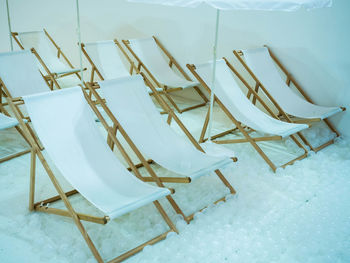 High angle view of empty chairs on table