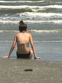 Rear view of young woman at beach