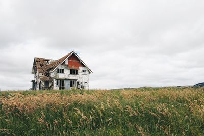 House on field against sky