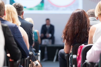 Rear view of people sitting in conference