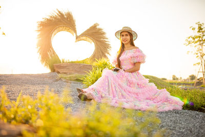 Woman standing by plants against sky
