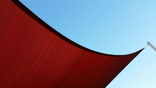 Low angle view of red tent  against clear, blue  sky