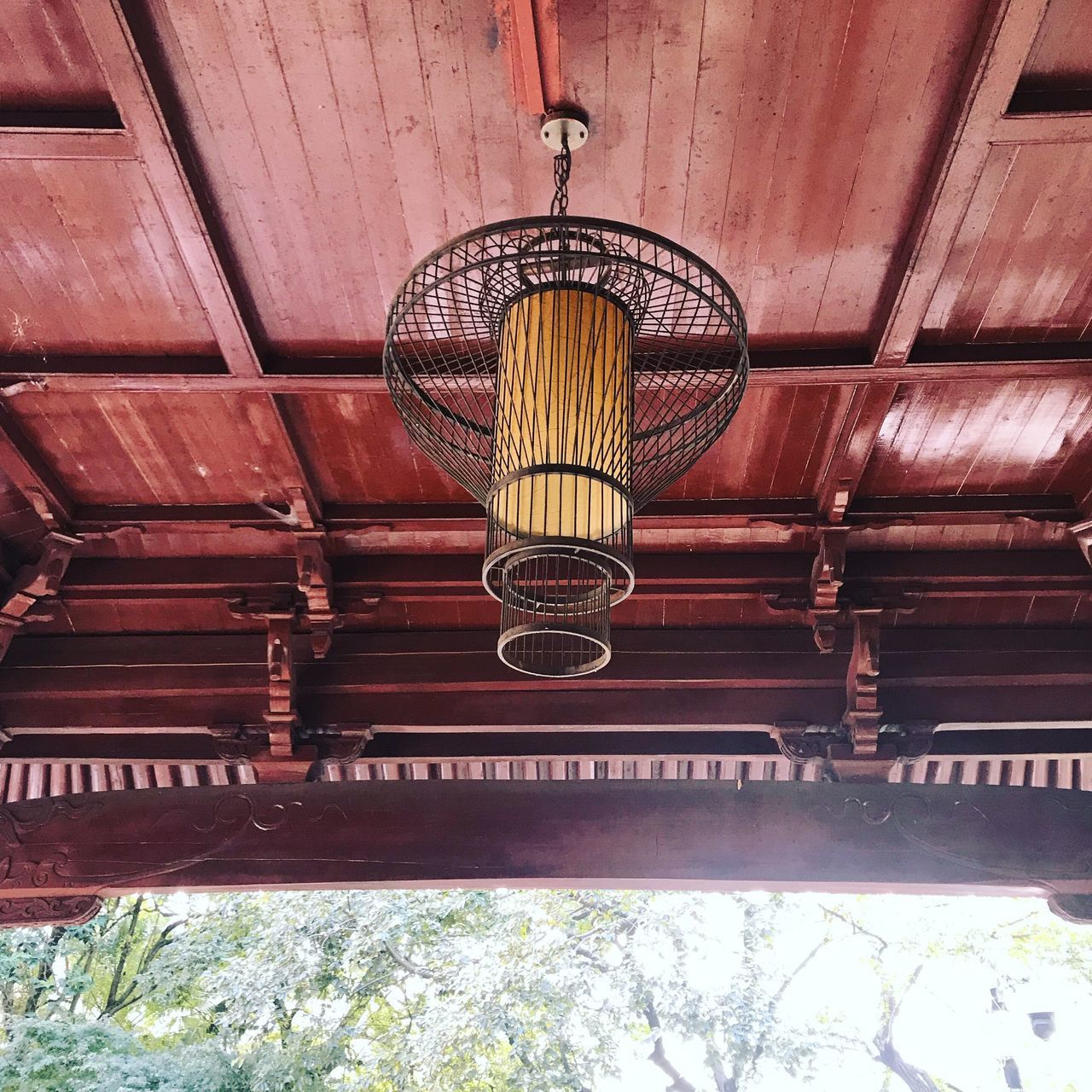 hanging, low angle view, lighting equipment, no people, built structure, ceiling, lantern, architecture, indoors, day