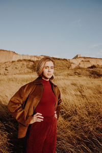 Woman standing on field against sky