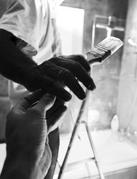 Close-up of hands holding brush