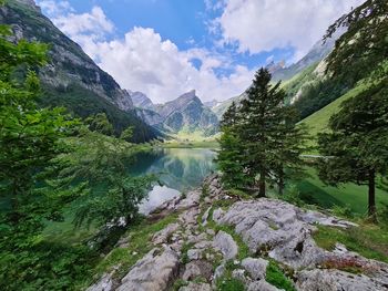Scenic view of lake and mountains against sky