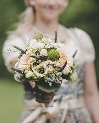 Close-up of woman holding flowering plant