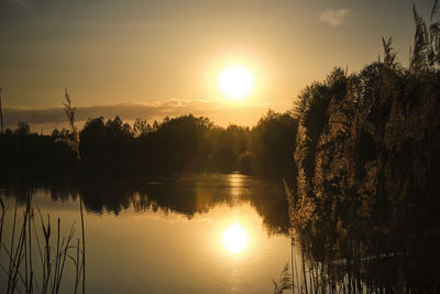 Scenic view of lake against sky during sunset