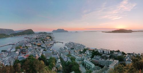 High angle view of city by sea against sky