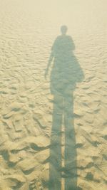 Shadow of person on sand