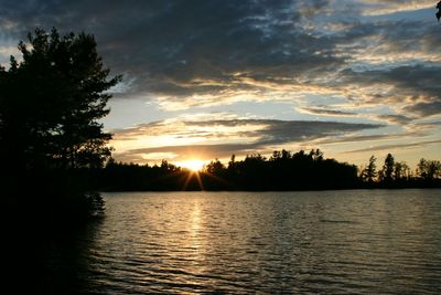 Scenic view of river at sunset