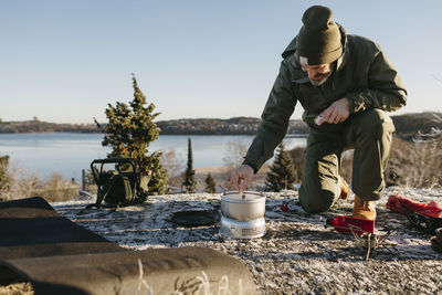 Man preparing food outdoors at winter