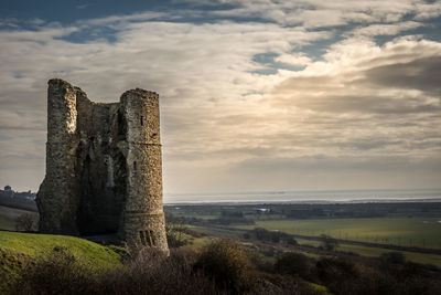 Hadleigh castle on field against cloudy sky