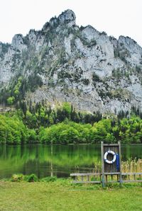 Scenic view of lake by mountains against sky