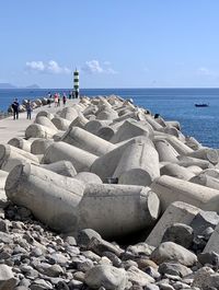 Rocks on beach against sky