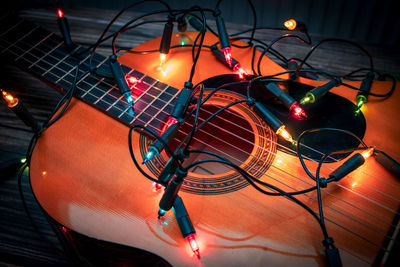 Close-up of christmas lights on guitar