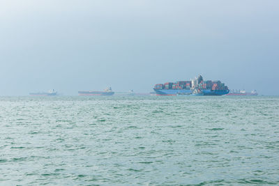 Ship sailing on sea against sky