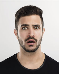 Portrait of young man against white background