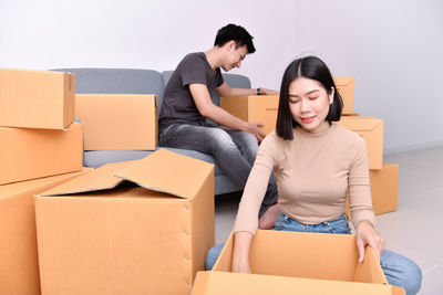 Young couple unpacking boxes at home