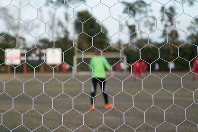 Full frame shot through soccer goal