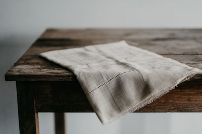 Close-up of paper on wooden table