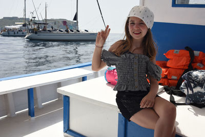 Portrait of young woman sitting in boat