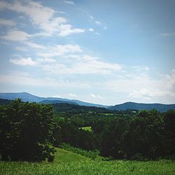 Scenic view of landscape against cloudy sky