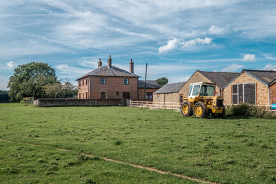 Abandoned house on field against sky
