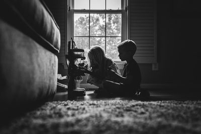 Children sitting on floor at home