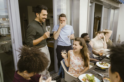 Portrait of smiling friends using digital tablet