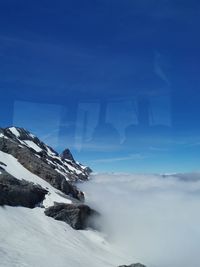 Scenic view of snowcapped mountain against sky