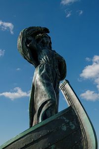 Sculpture of a female sailor on a boat, view from below