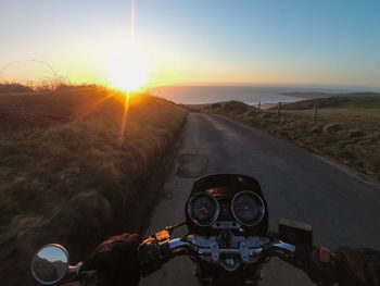 Close-up of road against clear sky during sunset